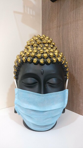 File:Buddha head statue with mask.jpg